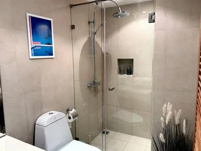 a shower stall in a bathroom with a toilet at Boho chic sea view apartment in Kata in Kata Beach