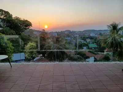 a view of a sunset from a patio at Boho chic sea view apartment in Kata in Kata Beach