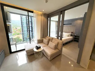 a living room with a couch and a bed at Deluxe apartment Citygate Condo by Lofty in Kamala Beach