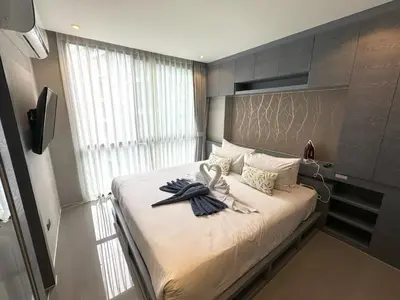 a bedroom with a bed with towels on it at Deluxe apartment Citygate Condo by Lofty in Kamala Beach