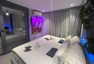 a bedroom with a bed with white sheets and pillows at Deluxe apartment Citygate Condo by Lofty in Kamala Beach