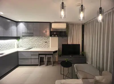 a kitchen and living room with a couch and a table at Deluxe apartment Citygate Condo by Lofty in Kamala Beach