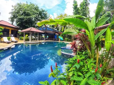 a pool at a resort with trees and plants at Charming Pool Twin Holiday Home in Patong Beach