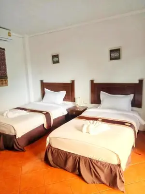 a hotel room with two beds with white sheets at Charming Pool Twin Holiday Home in Patong Beach