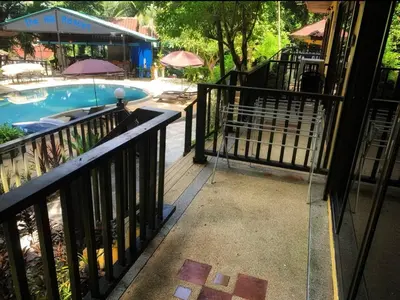 a balcony with a swimming pool and a building at Charming Pool Twin Holiday Home in Patong Beach
