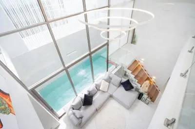 an overhead view of a living room with a chandelier at New Modern Aesthetic 3-Storey Villa A15 in Gated Residence just 10 min drive Laguna Phuket in Bang Tao Beach
