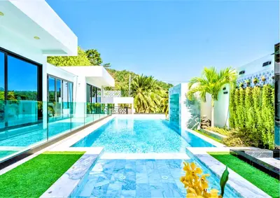 a swimming pool in the backyard of a house at Zen-Inspired Villa Retreat, Resort-Style Pool, Stunning Rooftop & Kid-Friendly Playground in Rawai Beach