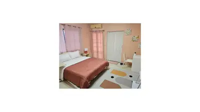 a bedroom with a bed and a desk in a room at Angels 