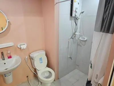 a bathroom with a shower and a toilet and a sink at Angels 