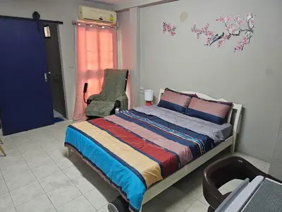 a bedroom with a bed and a chair and a window at Angels 