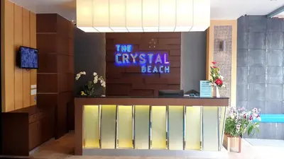 a sign that says the gypsypelled beach in a lobby at The Crystal Beach Hotel in Patong Beach