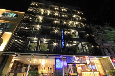 a building with lights on top of it at night at The Crystal Beach Hotel in Patong Beach