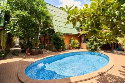 a large blue swimming pool in front of a house at Bungalow Phuket in Kamala Beach