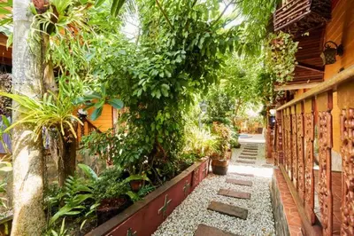 a garden with trees and plants on a building at Bungalow Phuket in Kamala Beach