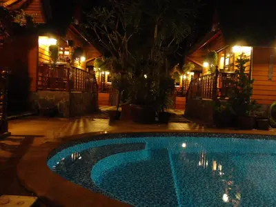 a swimming pool in a yard at night at Bungalow Phuket in Kamala Beach