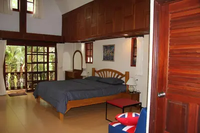 a bedroom with a king sized bed in a room at Bungalow Phuket in Kamala Beach