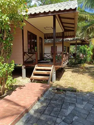 a small house with a porch and a wooden staircase at Mangrove House Kohyao noi in Ban Bang Chak