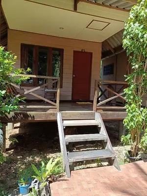 a front porch of a house with a red door at Mangrove House Kohyao noi in Ban Bang Chak