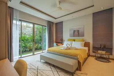 a bedroom with a bed and a large window at 3BR Villa with Pool at Anchan Hills in Bangtao in Bang Tao Beach