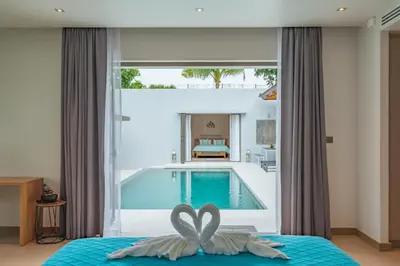 a bedroom with a swimming pool next to a bed at 3BR Villa with Pool at Anchan Hills in Bangtao in Bang Tao Beach