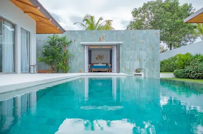 a swimming pool in front of a house at 3BR Villa with Pool at Anchan Hills in Bangtao in Bang Tao Beach