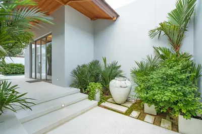a courtyard with plants and a large vase at 3BR Villa with Pool at Anchan Hills in Bangtao in Bang Tao Beach