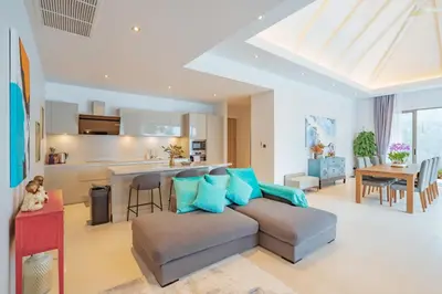 a living room with a couch and a kitchen at 3BR Villa with Pool at Anchan Hills in Bangtao in Bang Tao Beach