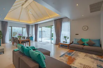 a living room with a couch and a table at 3BR Villa with Pool at Anchan Hills in Bangtao in Bang Tao Beach