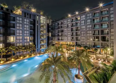 an overhead view of a pool with palm trees in front of buildings at Citygate Condo Kamala Phuket in Kamala Beach