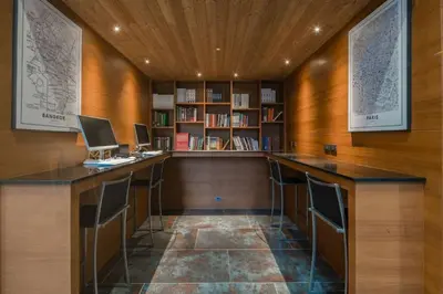 a library with two desks with computers on them at Citygate Condo Kamala Phuket in Kamala Beach