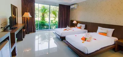 a hotel room with two beds and a television at The Pano Hotel And Residence in Ao Nang Beach
