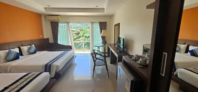 a hotel room with two beds and a television at The Pano Hotel And Residence in Ao Nang Beach