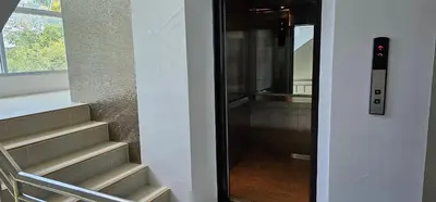a glass door leading to a staircase in a house at The Pano Hotel And Residence in Ao Nang Beach