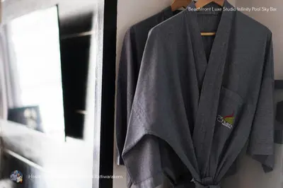 a robe hanging on a rack next to a mirror at Beachfront Deluxe Infinity Pool in Patong Beach