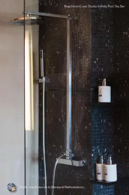 a shower with two rolls of toilet paper in a bathroom at Beachfront Deluxe Infinity Pool in Patong Beach