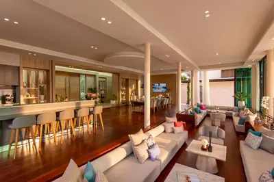 a living room with a couch and a bar at Villa Boonta in Phuket Town