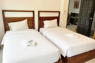 two beds sitting next to each other in a room at Peacefully Rawai 3 Bedrooms Pool Villa in Rawai Beach