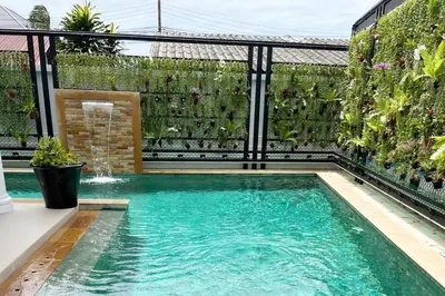 a swimming pool in the middle of a backyard at Peacefully Rawai 3 Bedrooms Pool Villa in Rawai Beach