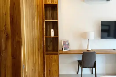 a room with a desk with a chair and a television at Peacefully Rawai 3 Bedrooms Pool Villa in Rawai Beach