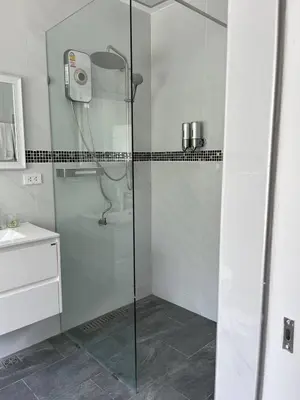a shower with a glass door in a bathroom at Peacefully Rawai 3 Bedrooms Pool Villa in Rawai Beach