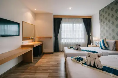 a hotel room with two beds and a sink at iCheck inn Central Patong in Patong Beach