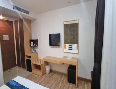 a hotel room with a desk and a tv at iCheck inn Central Patong in Patong Beach