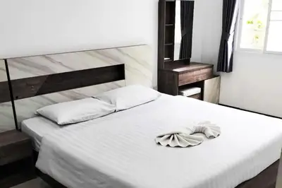 a white bed with a towel on top of it at 2 Bedrooms Pool Villa in Kamala in Kamala Beach