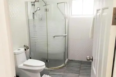 a bathroom with a toilet and a glass shower at 2 Bedrooms Pool Villa in Kamala in Kamala Beach