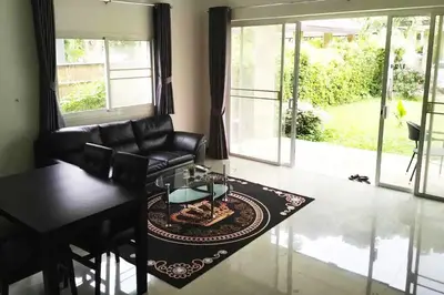 a living room with a black leather couch and a table at 2 Bedrooms Pool Villa in Kamala in Kamala Beach