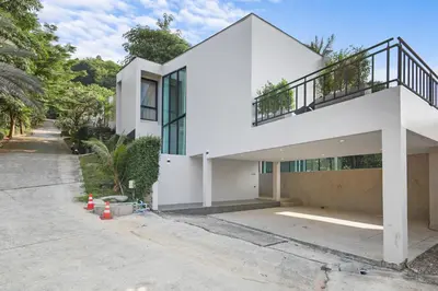 a white house with a staircase on top of it at Canary Villa - Kamala Beach in Kamala Beach