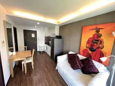 a living room with a white couch and a painting on the wall at Cozy apartment at The Title Rawai by Lofty in Rawai Beach