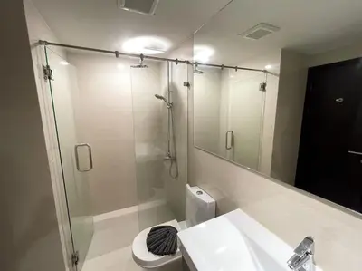 a bathroom with a shower and a toilet and a sink at Cozy apartment at The Title Rawai by Lofty in Rawai Beach