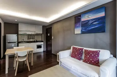 a living room with a white couch and a table at Cozy apartment at The Title Rawai by Lofty in Rawai Beach