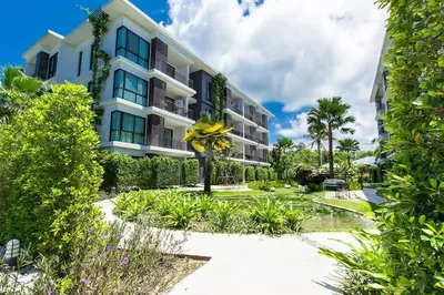 an apartment building with a garden in front of it at Cozy apartment at The Title Rawai by Lofty in Rawai Beach
